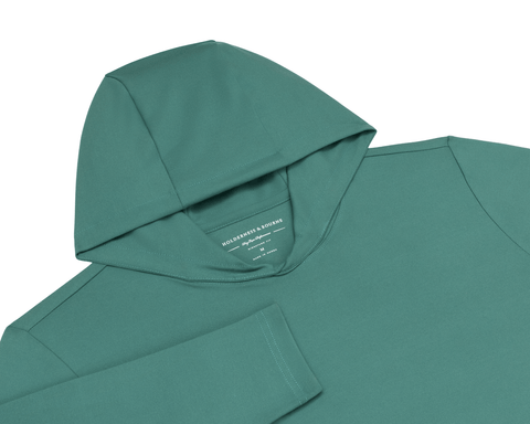 The Jackson Hoodie: California Spruce flat-lay showing the hood, long sleeves, and inside collar label with Holderness & Bourne branding.
