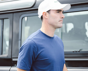 Man wearing Holderness & Bourne Men’s Navy Blue Cotton T-Shirt with white cap