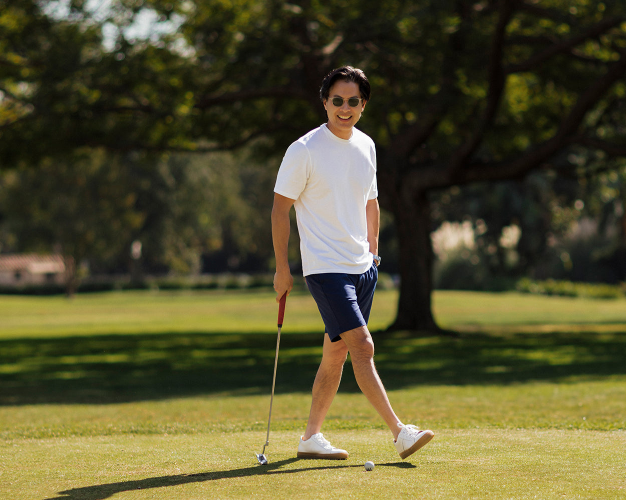 Man wearing Holderness & Bourne Men’s Pima Cotton White T-Shirt while golfing outdoors