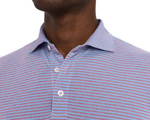 Close-up of a model wearing The Maxwell Shirt: Vista Blue & Heathered Faded Mauve, showing the spread collar, placket, and fine blue and mauve stripes.