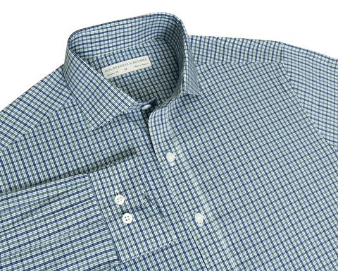 The Mendenhall Shirt: California Spruce & Navy flat-lay showing its two-color plaid, cutaway collar with brand label, button cuffs, and front placket.