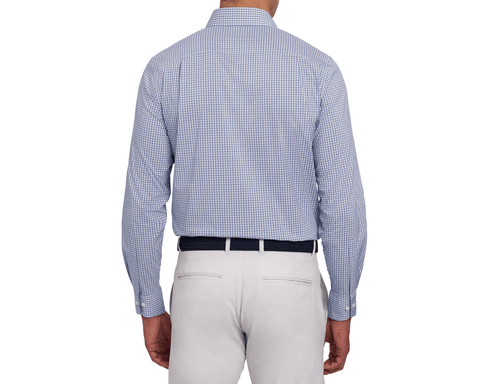 Back view of a male model wearing The Mendenhall Shirt: Sonoma & Pacific Blue, showing the plaid yoke and cuffs, with a navy woven belt and light gray pants.