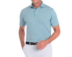 Man wearing The Perkins Shirt: Harbor & White, a turquoise-blue striped polo with structured collar, paired with off-white pants and a dark woven belt.
