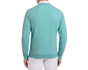 The Kennedy Crewneck: Heathered Harbor shown from the back, highlighting its relaxed fit and long sleeves, paired with light pants in a studio setting.