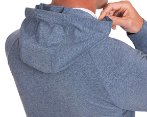A person adjusts the hood of The Dunbar Hoodie: Heathered Andover, showcasing its lightweight, breathable design ideal for active days.