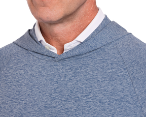 Close-up of person wearing The Dunbar Hoodie: Heathered Andover, featuring a white collared shirt underneath, showcasing its modern fit and technical performance design.