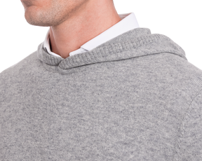 The Logan Hoodie Sweater in Heathered Gray, showcasing ribbed edging and layered over a white collared shirt, highlights its minimalist and versatile design.