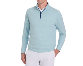 The Bell Quarter-Zip: Heathered Harbor, showcasing a light-blue pullover with a quarter-zip, layered over a white shirt, paired with light-gray trousers.