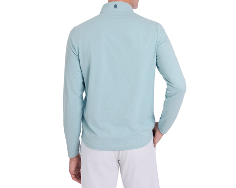 Person in The Bell Quarter-Zip: Heathered Harbor, showcasing back view with logo on collar, left hand on hip, in a modern drop-tail silhouette.