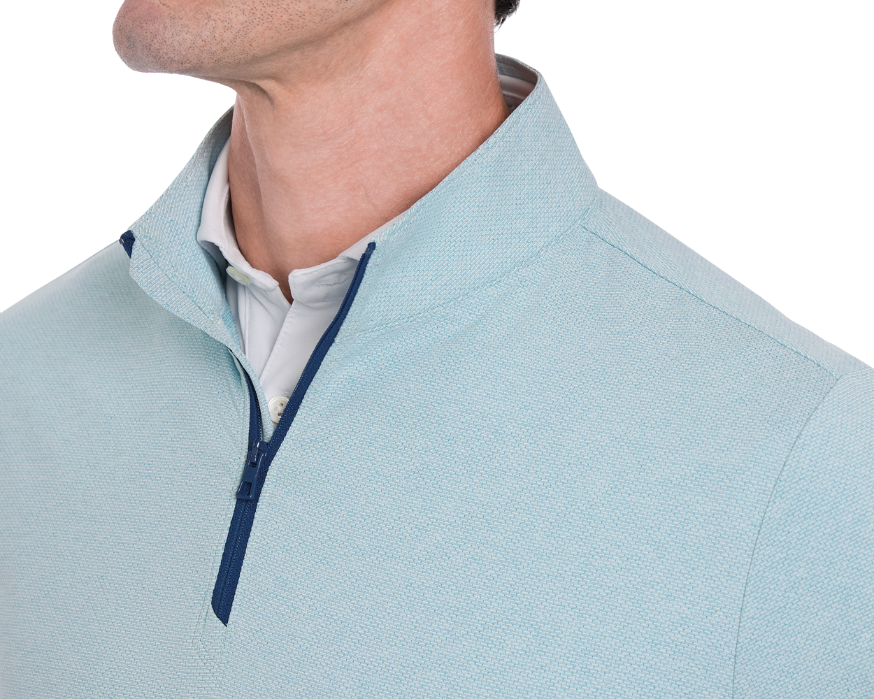 The Bell Quarter-Zip: Heathered Harbor features a textured light-blue pullover with a navy zipper, layered over a white collared shirt, showcasing its modern, sporty design.