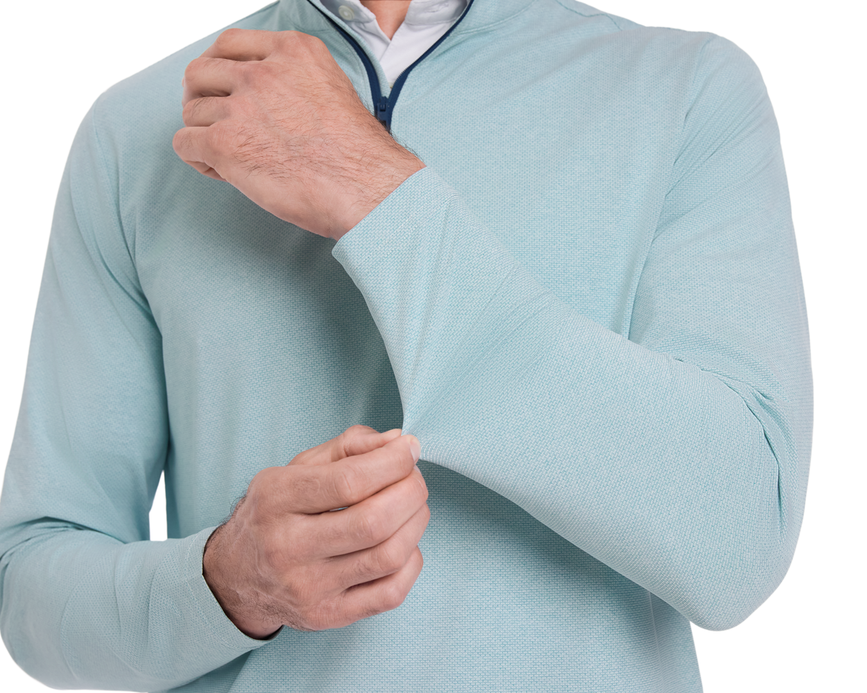 Person wearing The Bell Quarter-Zip: Heathered Harbor, adjusting a sleeve cuff of the light teal pullover, showcasing its modern drop-tail silhouette and signature fit.