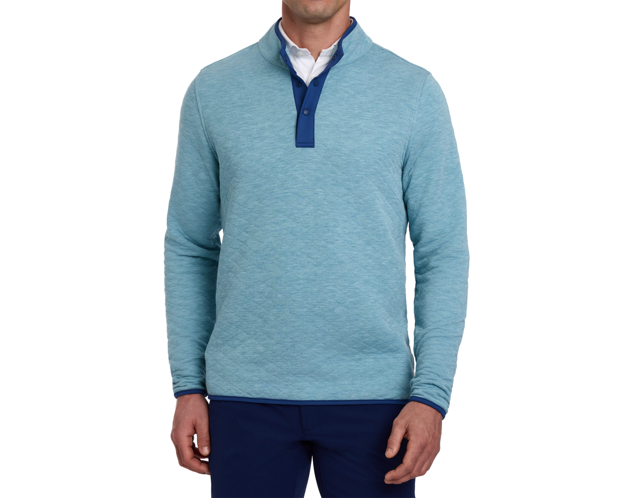 Man wearing The Sullivan Quarter-Snap: Heathered Harbor, showcasing its quilted texture, contrasting snap-placket, and collar lining, over a white shirt with dark trousers.