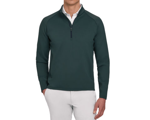 Model wearing The Rodgers Quarter-Zip: Cypress, featuring a half-zip, raglan sleeves, and low-profile side pockets, paired with a white polo and light gray pants.