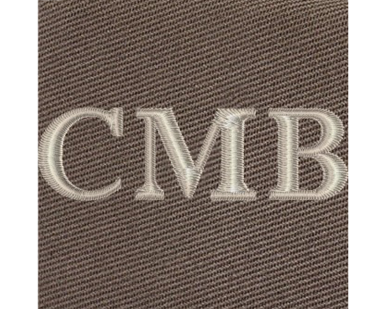 The Travis Tote Bag features cream-white CMB embroidery on brown woven fabric, showcasing personalized initials on its durable cotton twill design.