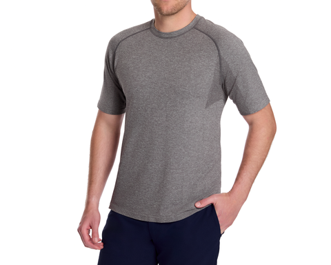 Man wearing The Pickett Performance T-Shirt in heathered gray, showcasing a seamless, breathable design ideal for athletic and casual wear, with his hand in his pocket.
